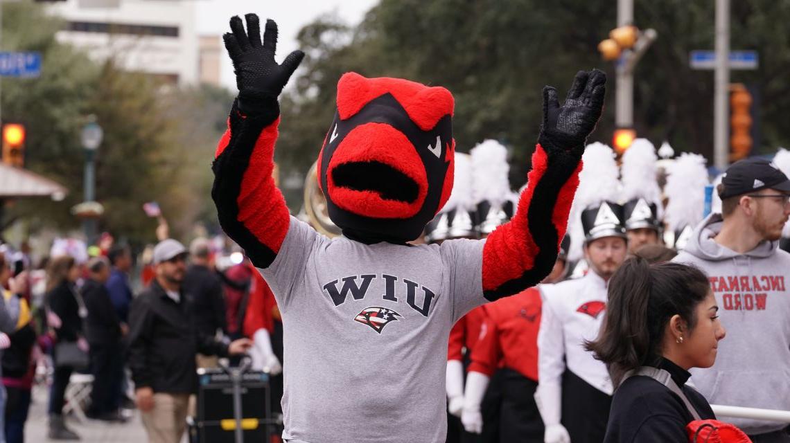 Red waving while marching in the parade 